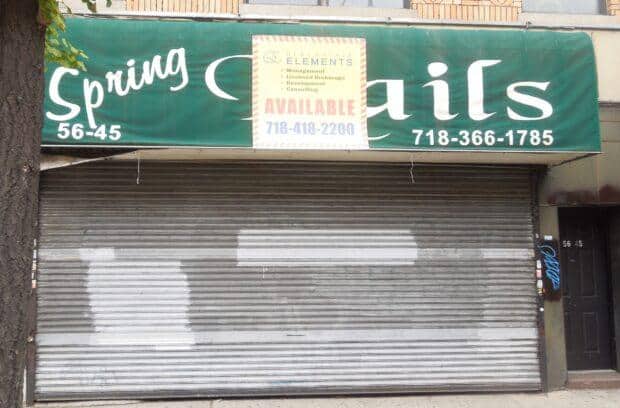 A closed storefront with a green "Spring Nails" sign, indicating nail salon services. The roller shutter is down, and a white and yellow sign above it shows "AVAILABLE" with a contact number, suggesting the property is for lease or sale. Address numbers 56-45 and 56-47 are visible.